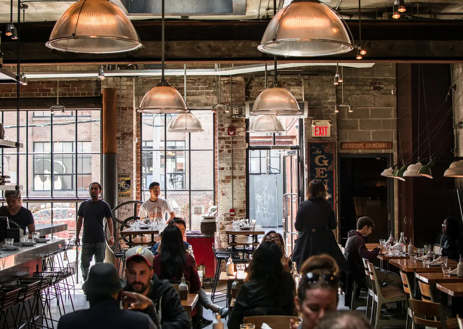 CafeHub interior with arched windows, plants and a coffee table